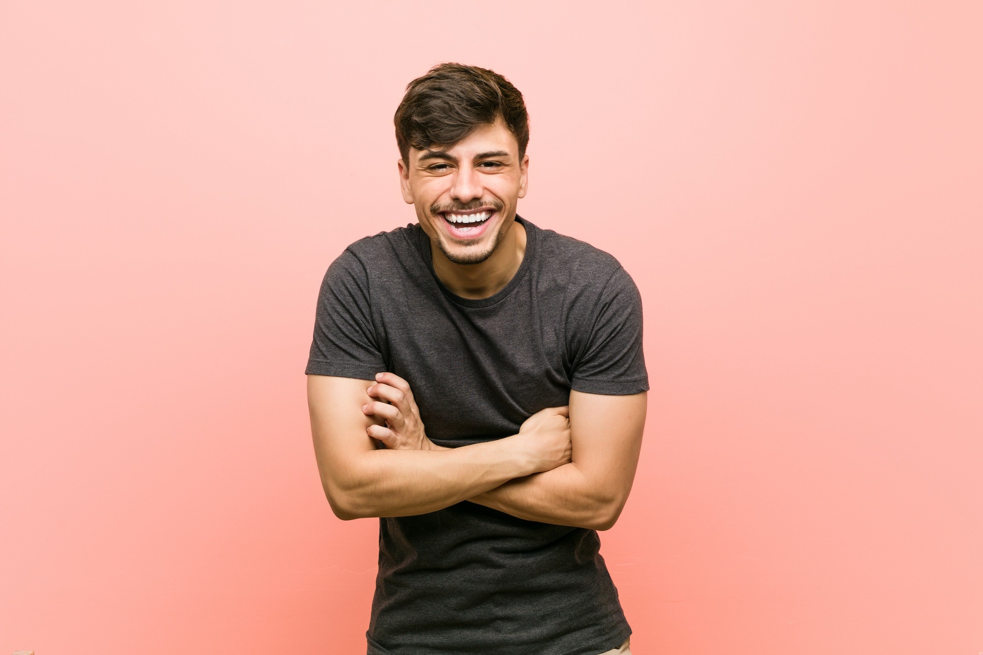 Young hispanic casual man laughing and having fun.