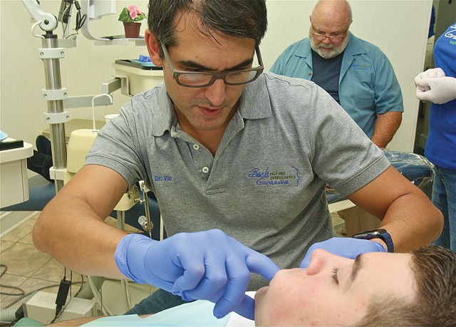 BARBARAELLEN KOCH PHOTODr. Victor Grazina examining a paitent's teeth after removing his braces Friday afternoon.